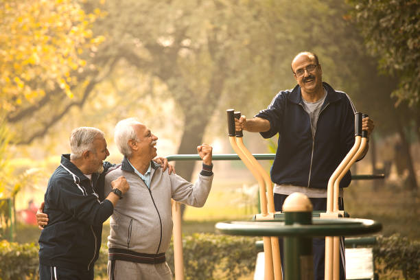 istock Friend motivating man exercising on cross trainer 1455283670