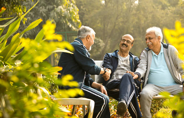 istock Old male friends having fun at park 1455283683