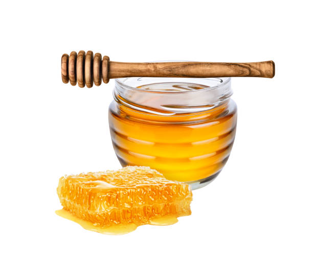 istock Jar with honey, honeycomb and honey dipper on white background. 1455284955