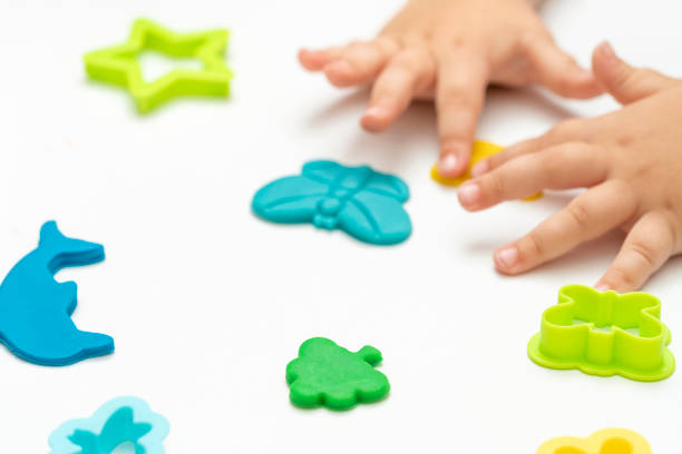 istock A little girl playing with play dough. Plasticine. 1455285001