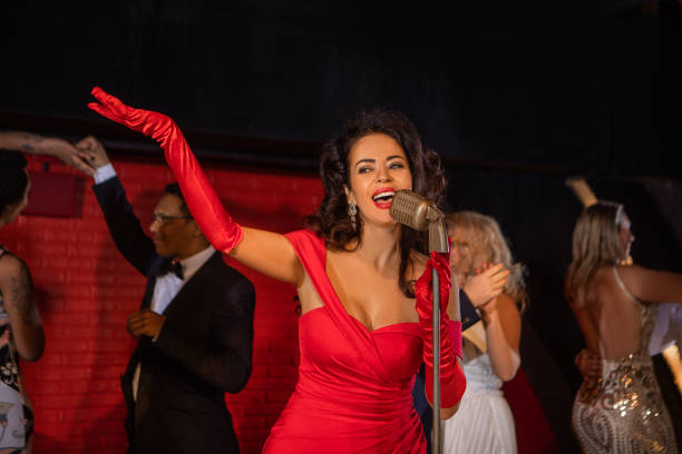 istock Beautiful female singer performing on stage with dancers 1455286536