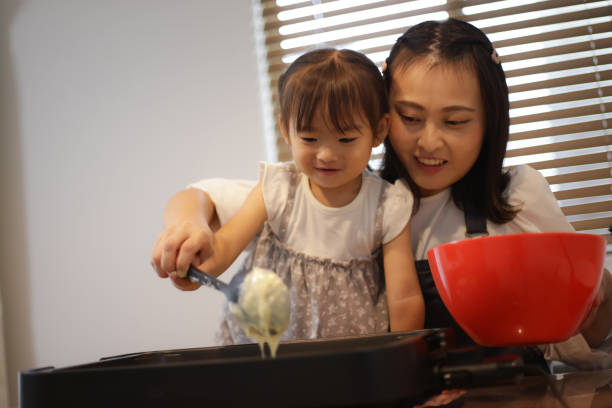 istock Parent and child baking hot cake 1455287690