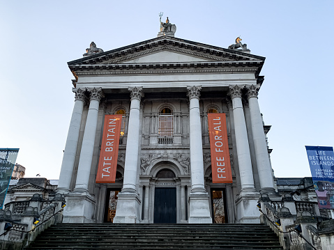 Imposing gallery with historic and contemporary British art, notable for its JMW Turner collection. Tate Britain exterior daytime view.