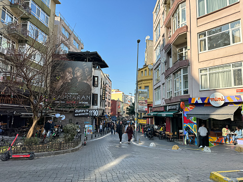 Moda area in Kadikoy district in Istanbul, Turkey. Crowded street in Kadikoy in autumn or winter time. Popular residential district for modern Turkish society. Street with popular cafes, restaurants, shops.