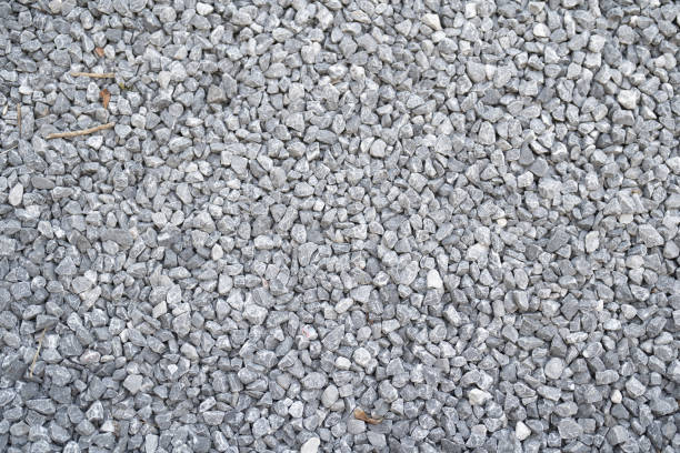 Granite gravel stone rocks flooring pattern surface texture. Close-up of exterior material for design decoration background. Rubble stock photo