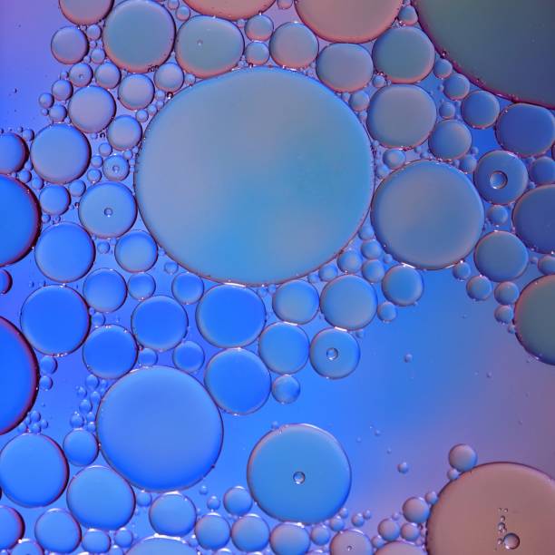 istock multi colored oil circles on the water, colorful abstract background 1455289556