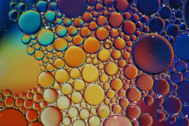 istock multi colored oil circles on the water, colorful abstract background 1455289576