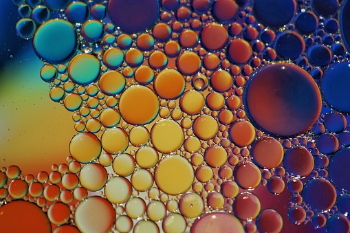 multi colored oil circles on the water, colorful abstract background