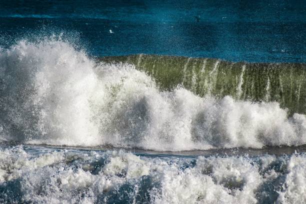 istock Big waves splashing and hitting the shore 1455291030