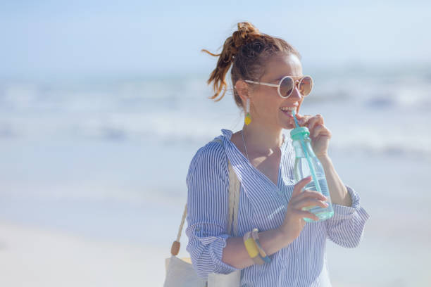 istock smiling elegant 40 years old woman at beach 1455291062