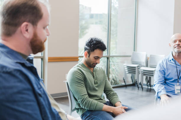 istock Mid adult man sits with his head down 1455291130