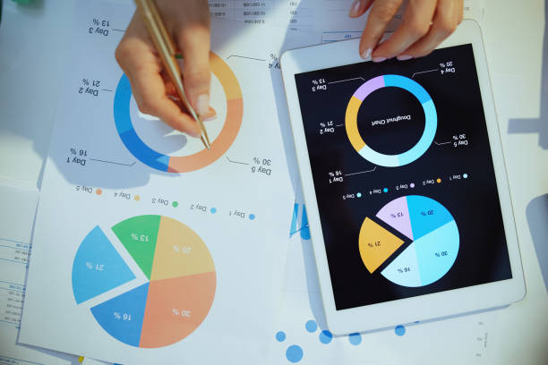 istock business woman with tablet pc working with documents and graphs 1455291282