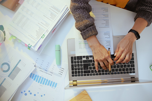 accountant woman with documents and laptop working.