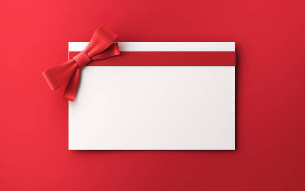 geschenkkarten mit roter schleife auf rotem hintergrund stockfoto - giftcard stock-fotos und bilder