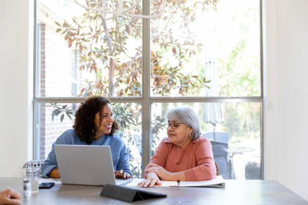 istock Adult daughter visits parents to help with paperwork 1455291871