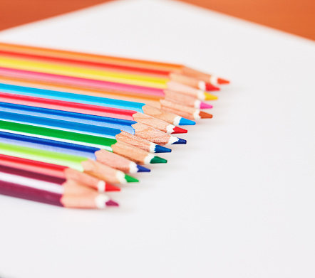 Row of colored pencils in all the colors of the rainbow.
