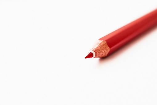 Close-up shot of a single red colored pencil.