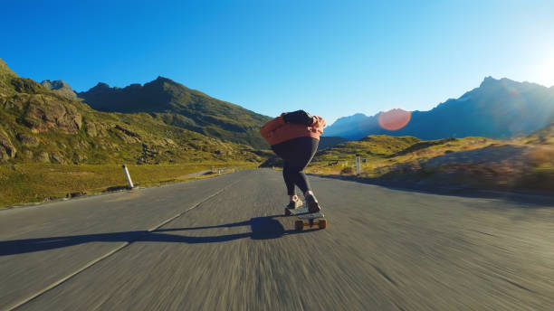 istock Woman doing downhill with longboard 1455292779