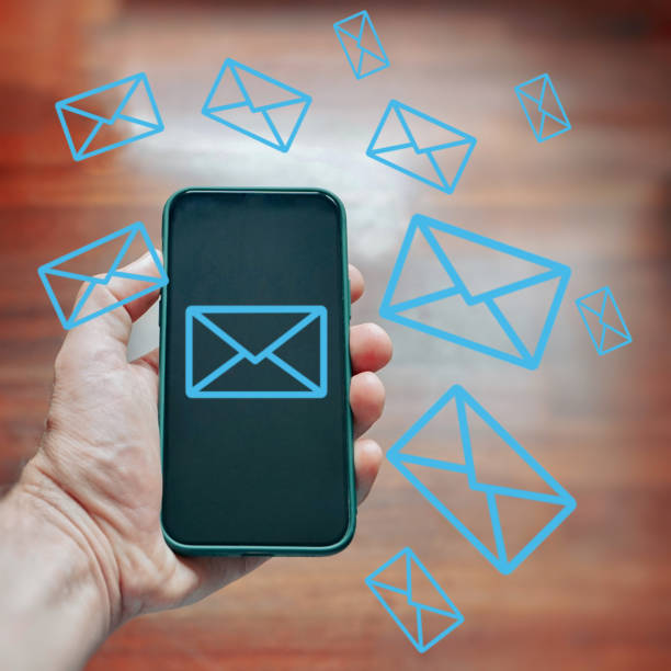 istock hand holding a mobile phone with email simbol, Telecommuting and e-work 1455293500