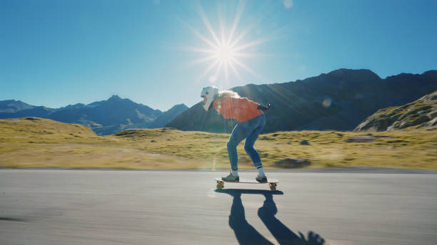 istock Woman doing downhill with longboard 1455293512