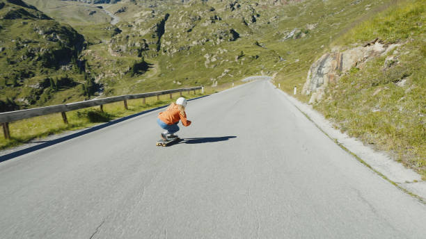 istock Woman doing downhill with longboard 1455293574