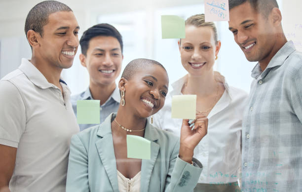 istock Sticky note, planning meeting and diversity teamwork on brainstorming, advertising success idea or marketing strategy. Glass board, collaboration and business people partnership working on sales goal 1455295626