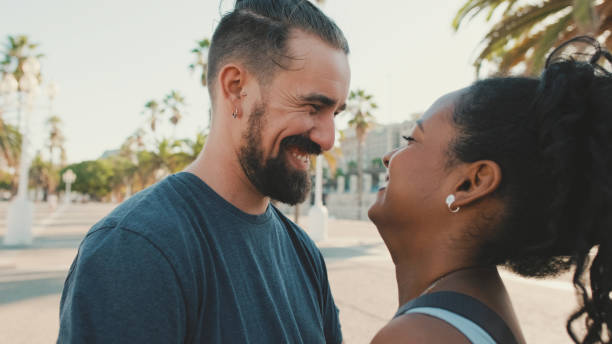 istock Happy interracial couple looking at each other 1455299724