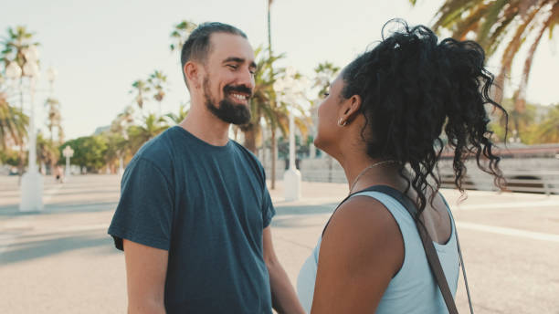 istock Happy interracial couple looking at each other 1455300129