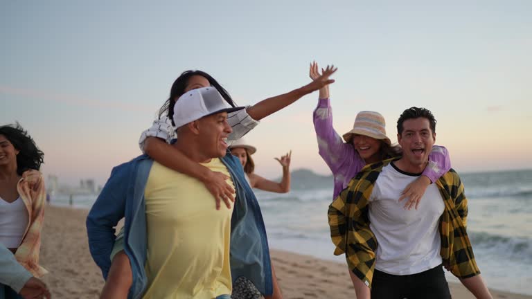 Friends walking and playing on the beach