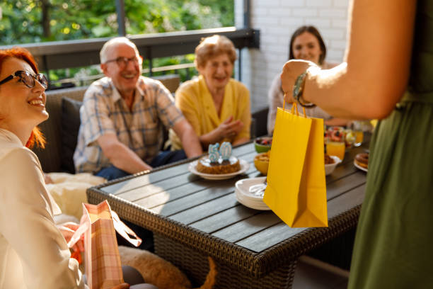 istock Cute little gift bag with a present for a senior couple's wedding anniversary celebration 1455302052