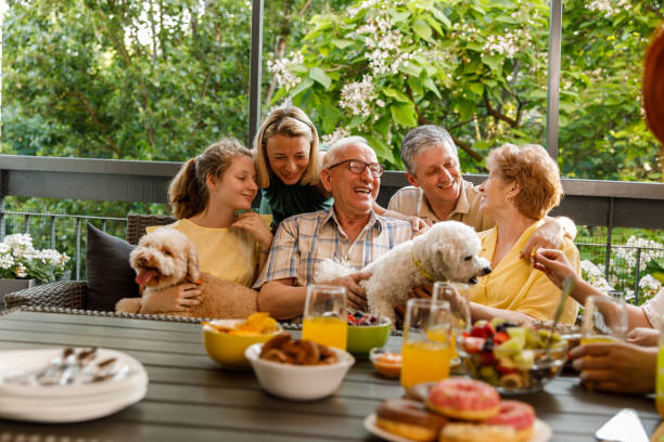 istock Three generation family cuddling and bonding during a celebratory party on the balcony 1455302342