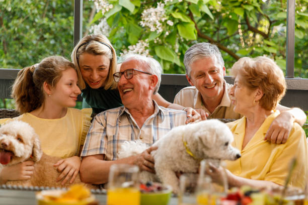 istock Three generation family cuddling and bonding during a celebratory party on the balcony 1455302349