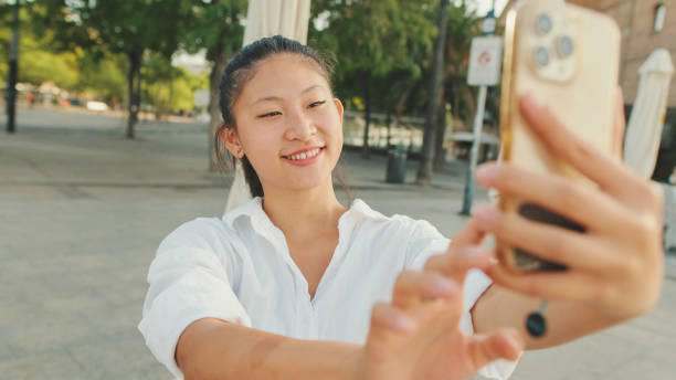 istock Young woman taking selfie on mobile phone 1455302655