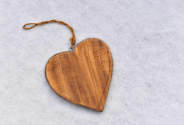 istock closeup on wooden shape  heart on the snow 1455302892