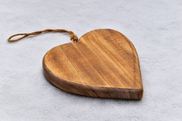 istock closeup on wooden shape  heart in the snow 1455302913