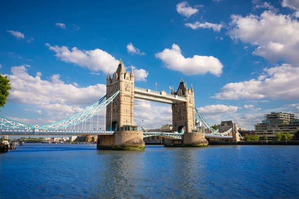 london tower bridge over thames river in a sunny blue sky summer day in uk - tower bridge stockfoto's en -beelden