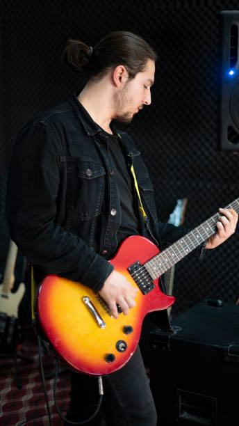 istock Long hair electric guitarist man 1455304057