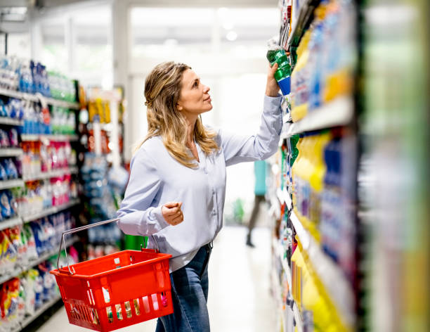 Woman customer buying groceries in supermarket stock photo