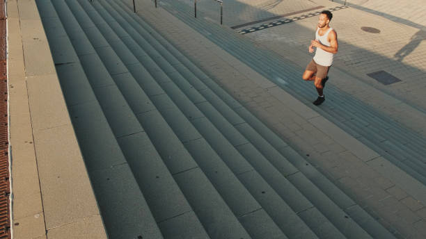 istock Young bearded man running up the stairs 1455304470