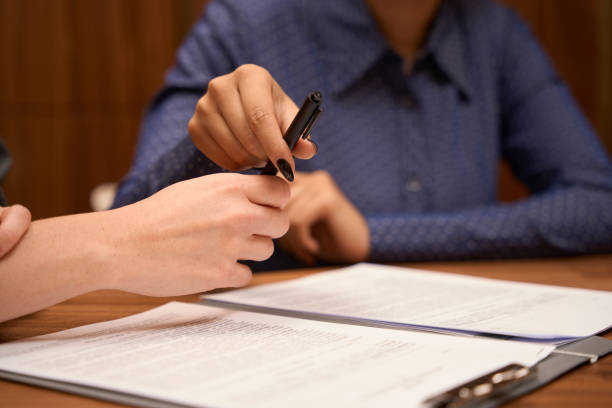 istock African American woman signs the document to start work 1455305056