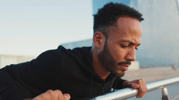 istock Close up, young bearded male athlete doing workout, push-ups on the waterfront 1455305090