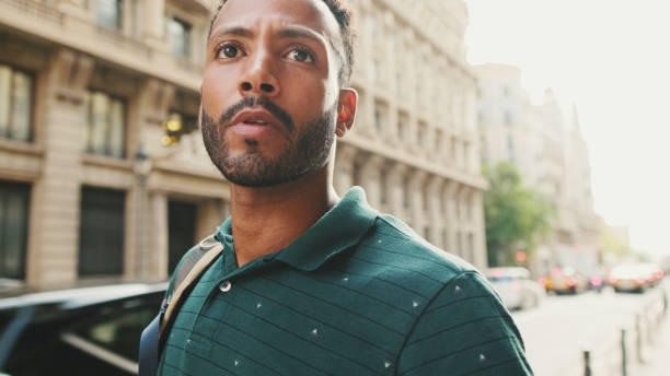 istock Young man walks down the street looking around 1455305376