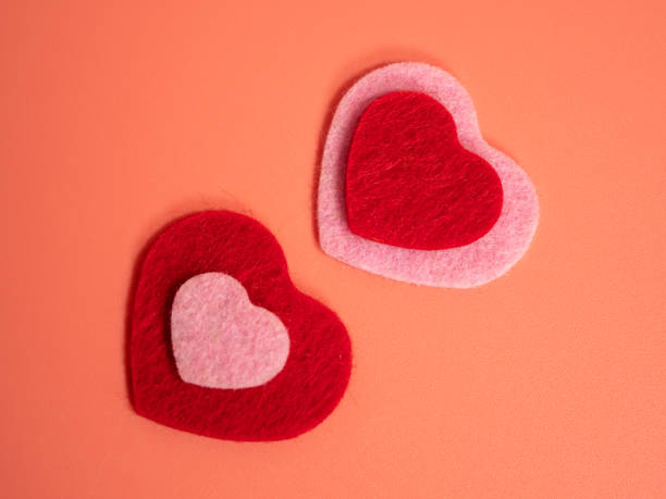 istock Heart of different colors on a pink background. 1455306571