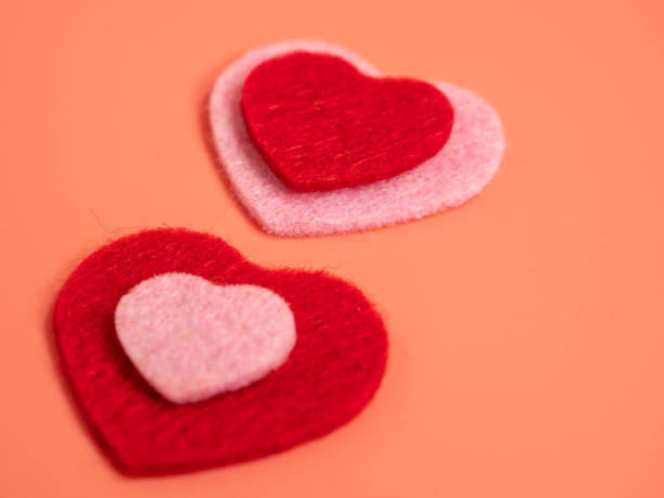 istock Heart of different colors on a pink background. 1455306587
