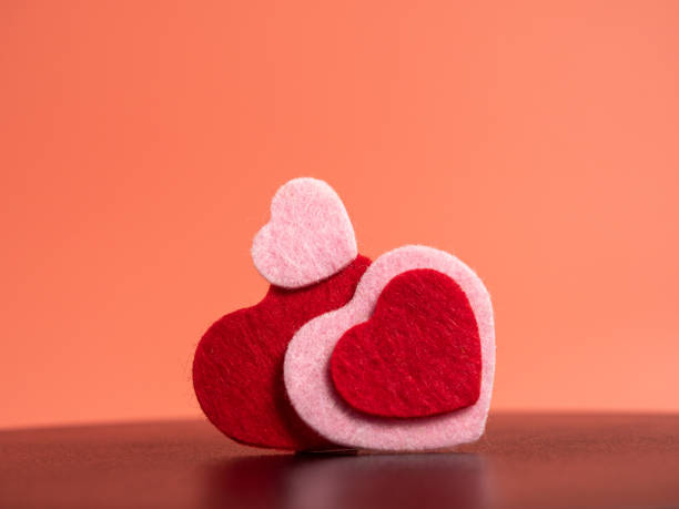 istock Heart of different colors on a pink background. 1455306615