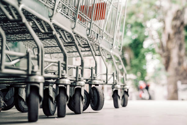 Row of empty shopping carts outside supermarket