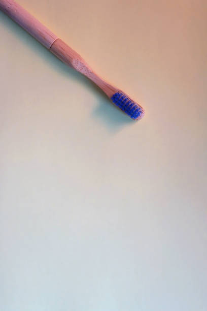 istock Wooden Toothbrush on Yellow Background 1455307574