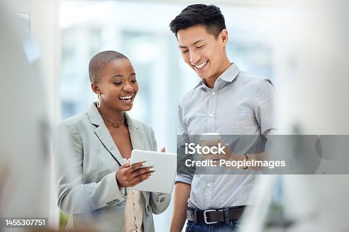 istock Tablet, smile and employees talking about business on the internet, online partnership and reading an email together at work. Marketing workers with idea for creative collaboration on technology 1455307751