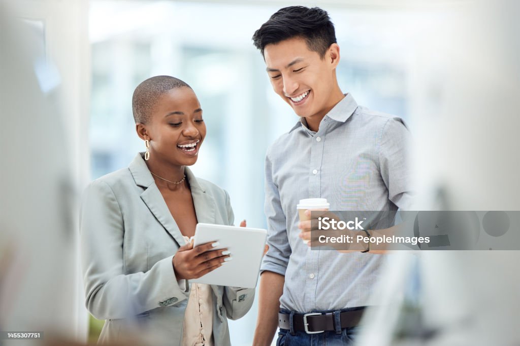 Tablet, smile and employees talking about business on the internet, online partnership and reading an email together at work. Marketing workers with idea for creative collaboration on technology Discussion Stock Photo