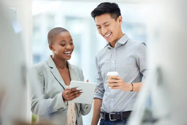 Photo of Tablet, smile and employees talking about business on the internet, online partnership and reading an email together at work. Marketing workers with idea for creative collaboration on technology